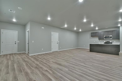 Empty room with recessed lighting, baseboards, and light wood-style floors