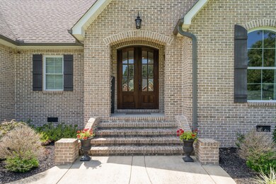 As you make your way up, your attention is drawn to the gorgeous wood and glass double doors. The combination of these materials adds a touch of sophistication and charm to the home's exterior.