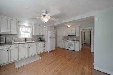 THE UPDATED KITCHEN FEATURES GLAZE CABINETRY AND A