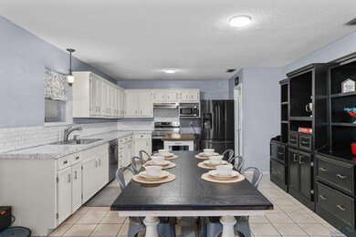 Kitchen featuring light tile patterned flooring, s