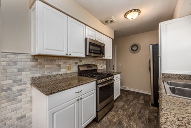 Kitchen has new white cabinets, SS appliances, gra