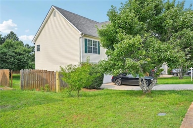 View of side of property featuring a shingled roof