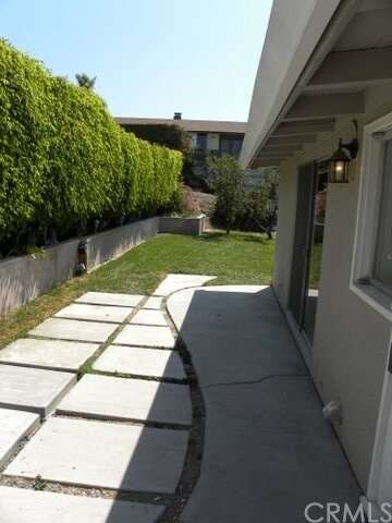 LARGE SIDE YARD WITH MANICURED GARDENS