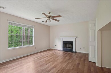 Unfurnished living room featuring wood finished fl