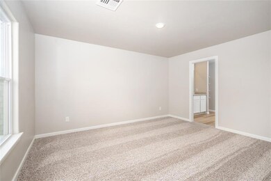 This spacious study featuring gorgeous french doors is the perfect spot for an office or playroom!