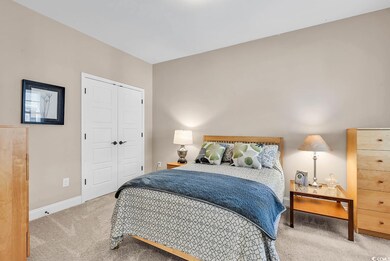 Carpeted bedroom with baseboards and a closet