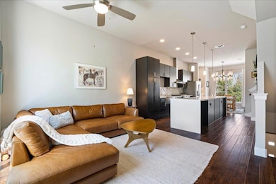 Living area with visible vents, baseboards, dark 