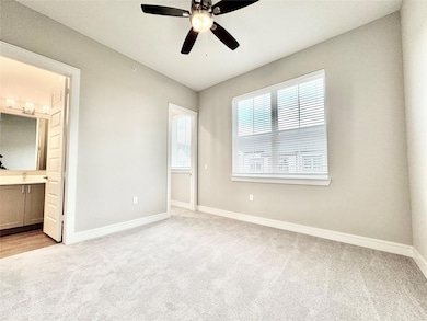 Unfurnished bedroom featuring ceiling fan, ensuite