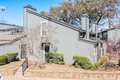 View of side of home with stucco siding and a chim
