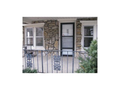 Detailed iron railing around covered front porch t