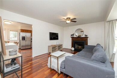 Living room with dark wood-flooring and ceiling fa