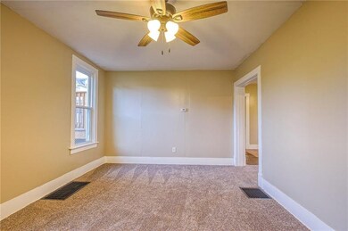 First floor living room with view of dining room.