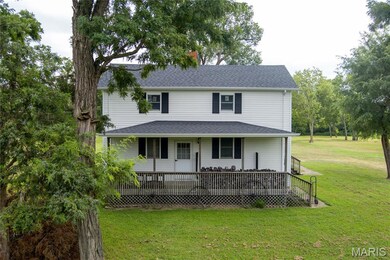 Front view of home and front lawn, and a wooden deck