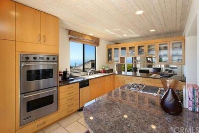 Gourmet Kitchen with custom cabinetry, stone floor