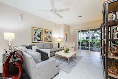 Living area featuring light tile patterned flooring and a ceiling fan