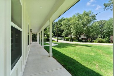 View of green lawn featuring a porch