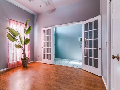 Empty room with french doors, wood finished floors, and plenty of natural light