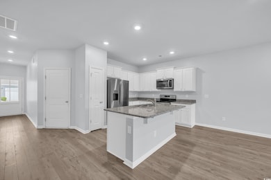 Kitchen with visible vents, a sink, wood finished 