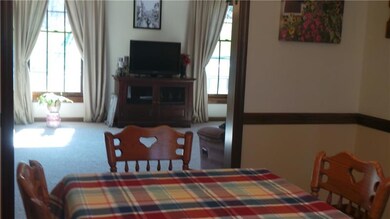 Dining room has chair rail and room for a large ta