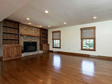 Great Room. Great room with gleaming hardwood floors and wood burning fireplace with built in bookcases