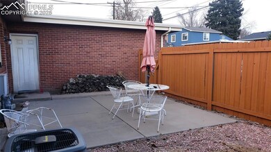 Back patio with privacy fence leading to the alley
