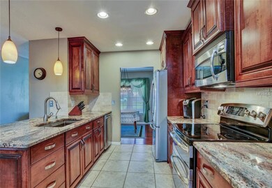The custom gourmet kitchen features rich, solid wo