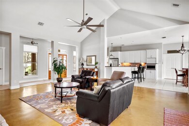 Living room featuring ceiling fan with notable ch