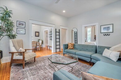 Living area with wood finished floors, recessed l
