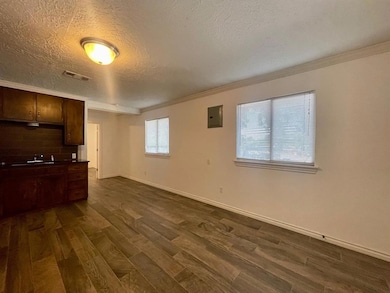 Unfurnished living room with a textured ceiling, v