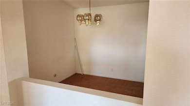 Unfurnished room with a chandelier