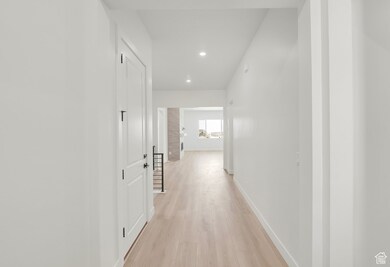 Hall featuring light wood-style floors and recessed lighting