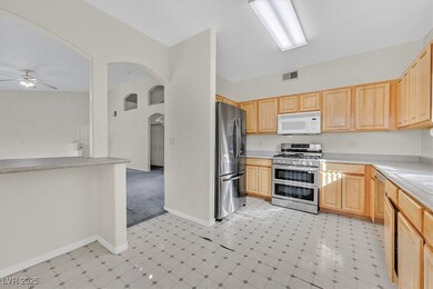 Kitchen with visible vents, arched walkways, stain