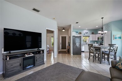 Living room featuring a chandelier, light tile pat