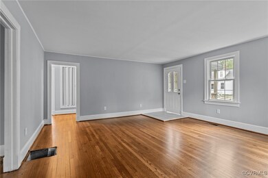 Unfurnished living room featuring visible vents, h