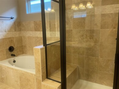 Jetted tub in Primary Bath and nice glass shower door with a bench in the shower as well!