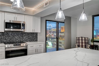 Kitchen featuring visible vents, light stone count