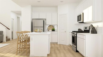 Kitchen with stainless steel appliances, an island