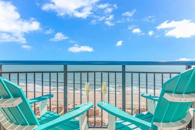 Balcony with a water view and a beach view