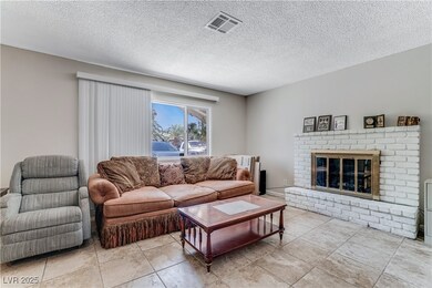 Tiled living area featuring a fireplace and a text