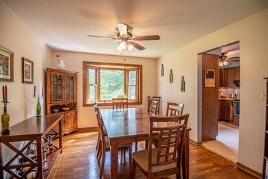 Formal dining room with bay window overlooking a b