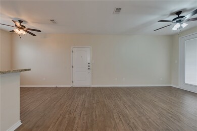 Unfurnished living room featuring wood finished fl