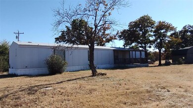 View of side of property with a sunroom