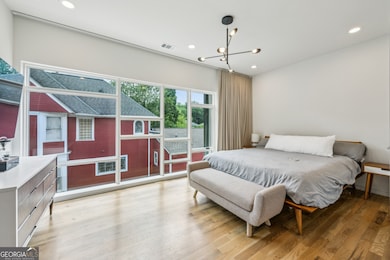 Upstairs, the Spacious Primary Suite feels like a High-End Hotel Escape, featuring a Wall of Windows, Large Walk-In Closet, and a Spa-Inspired Bathroom with Stone Double Vanity, Glass-Enclosed Shower, and Designer Finishes.