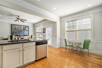 Kitchen with a sink, dark stone countertops, light