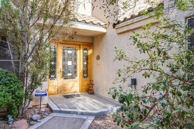 Property entrance featuring mature landscaping