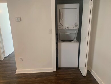 Washroom featuring dark wood-type flooring and sta