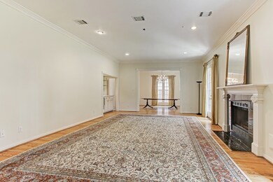 The Living Room is quite grand.  The outer wall is punctuated with French Doors that lead to the Garden.  To the right of frame is a wood burning fireplace that can accomodate gas logs.