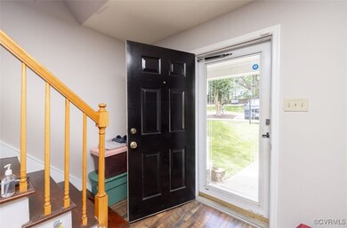 Foyer entrance featuring stairs and dark wood-styl