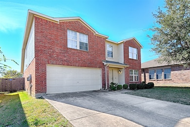 Traditional-style home with concrete driveway, an attached garage, and brick siding