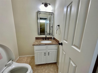 Bathroom with vanity and light tile patterned flooring